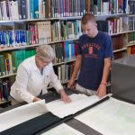 Photo: two people looking over paperwork on a table